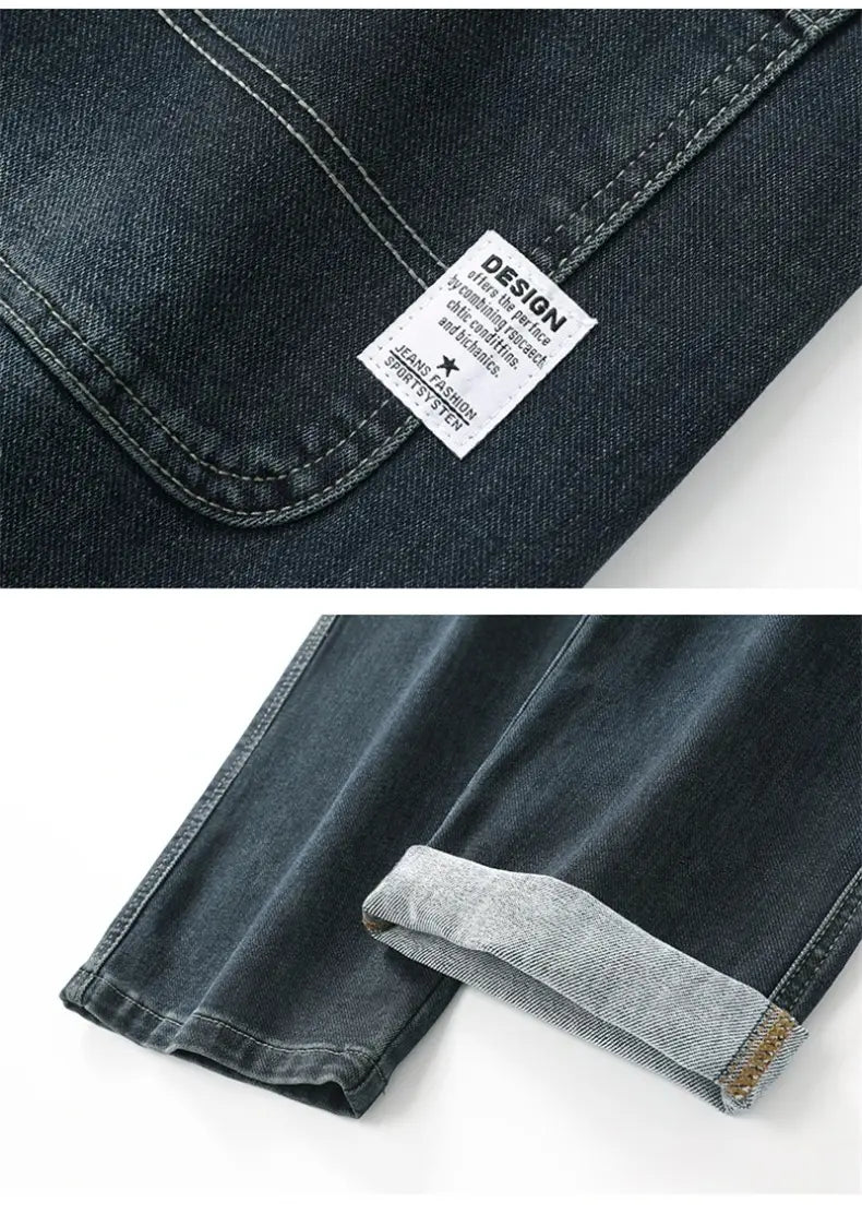 Men’s loose straight business casual dark-wash denim jeans with rolled cuff and visible stitching.