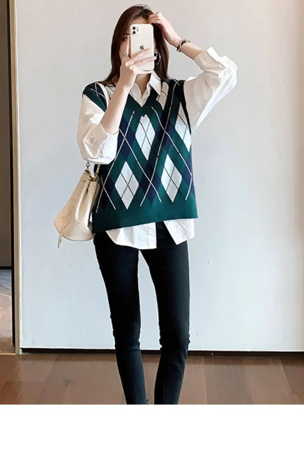 green argyle knit vest with white and navy accents worn over a solid white basic shirt oversized casual button up blouse