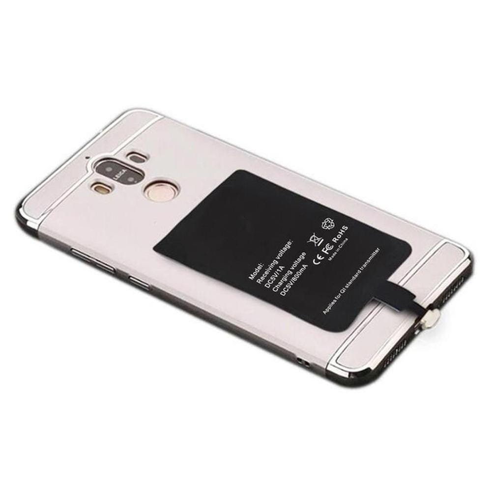 silver-framed smartphone showing the back side with a black wireless charging receiver charging pad attached for type c android phones.