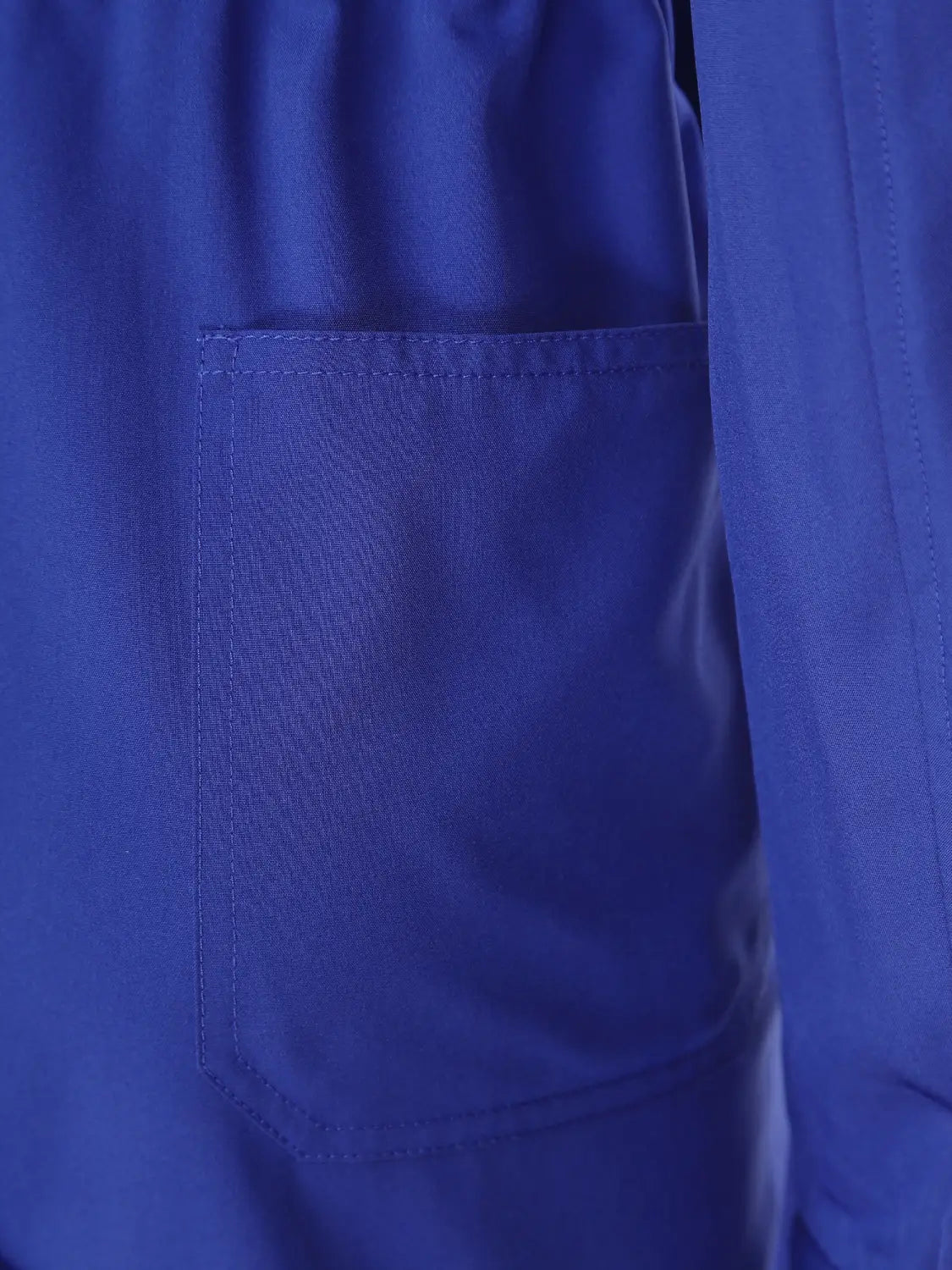 A royal blue long sleeve casual jumpsuit featuring a rich fabric pocket with neat stitching and subtle texture, suitable for work or utility use.