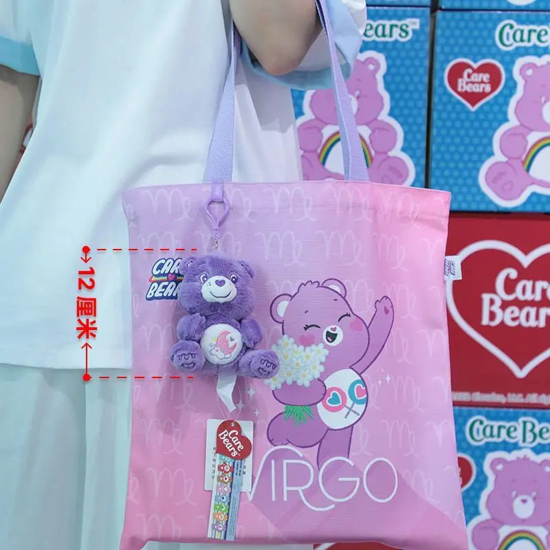 Pink care bears tote bag with a purple bear plush charm and the word Virgo printed in white featured in a care bears plush bag pendant keychain toy.