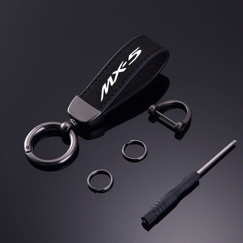 Black leather Mazda MX5 keychain car key ring holder with white MX5 logo and metallic hardware.