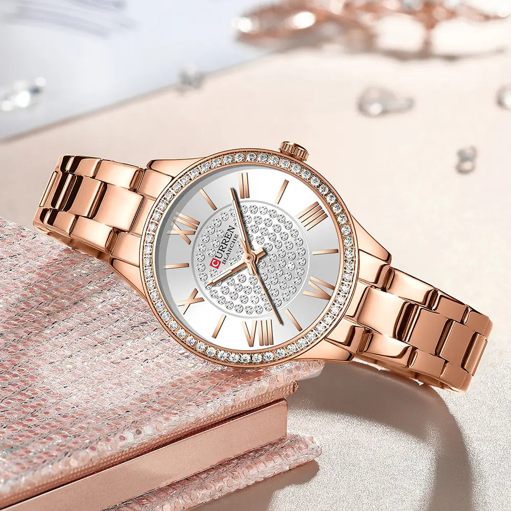 Rose gold curren women stainless steel crystal quartz watch with a diamond-studded bezel and roman numeral dial.