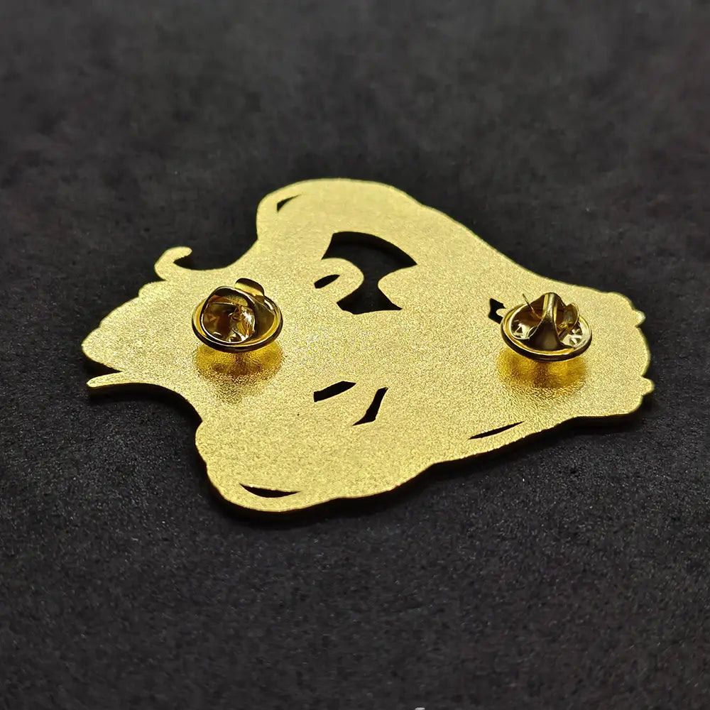 gold-colored metal enamel pin shaped like a stylized face with cut-out features from the Hatsune Miku anime collection