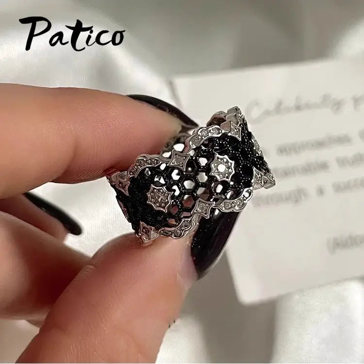 A patico brand sterling silver black geometric ring for women featuring an intricate honeycomb pattern with sparkling clear stones.