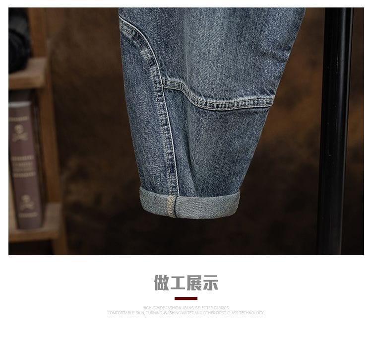 Men denim cargo jeans in blue denim with a rolled cuff and visible stitching designed as casual loose pants.