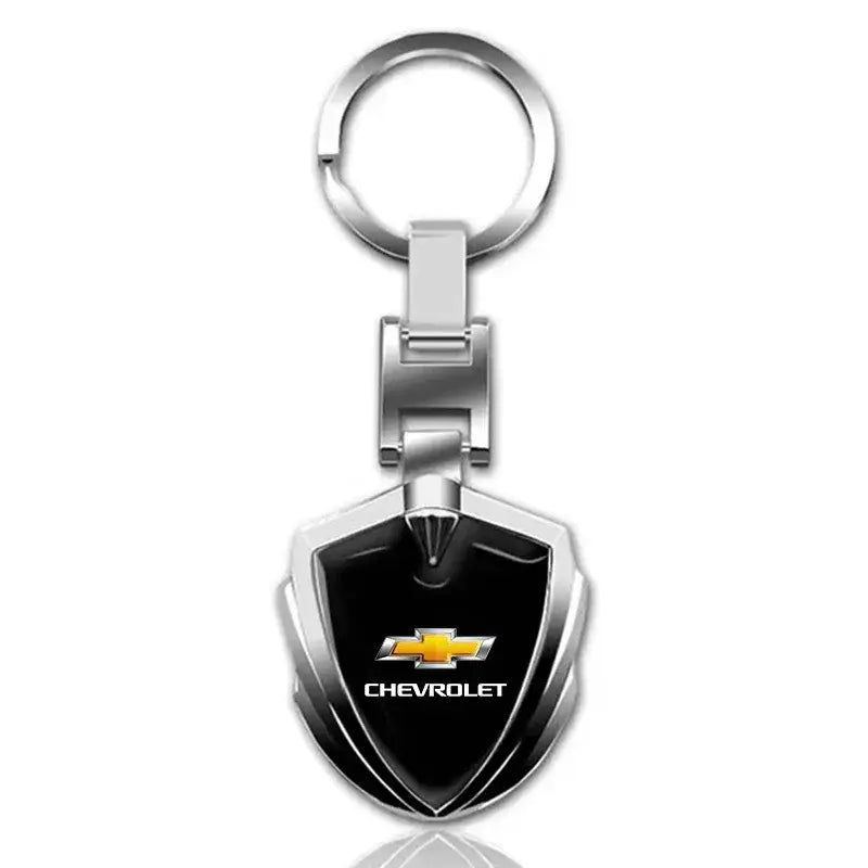 Silver metal shield-shaped Chevrolet car keychain with a black center featuring the gold Chevrolet logo and white Chevrolet text.