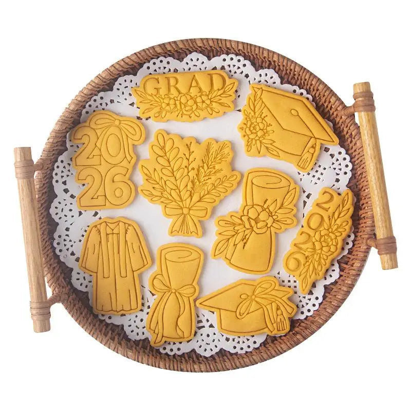 golden metal 2026 graduation cookie cutter set arranged on a woven tray for celebratory baking use