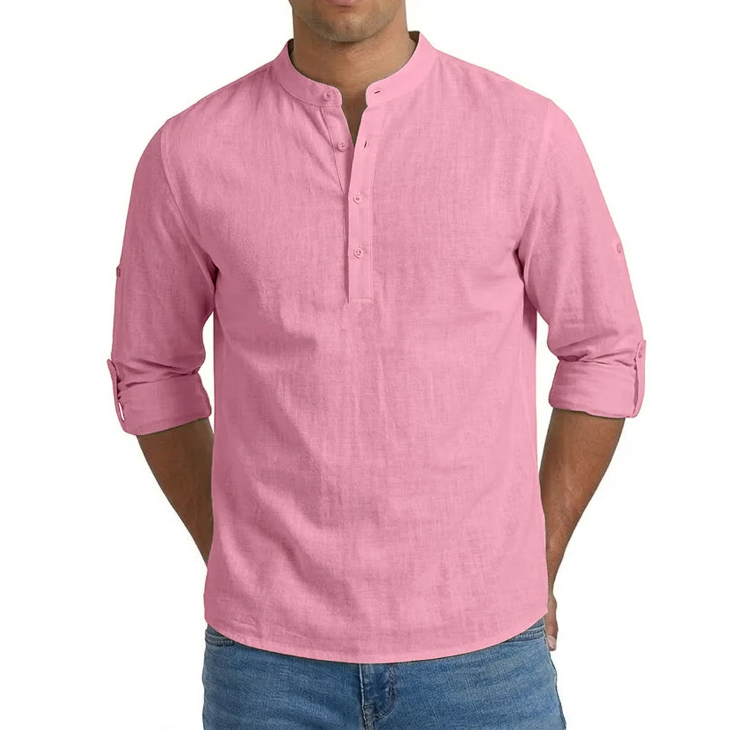 A soft pink men’s linen blend long sleeve henley shirt featuring a mandarin collar and buttoned placket.