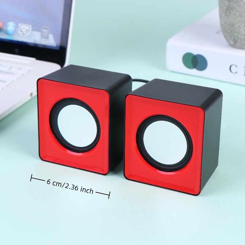 Haut-parleurs de bureau mini USB en forme de cube rouges et noirs, avec des haut-parleurs circulaires blancs pour l’audio stéréo sur ordinateur.