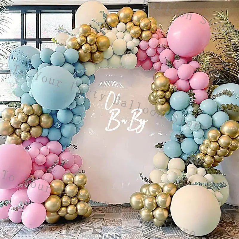A festive pink balloon arch kit for wedding and birthday parties featuring pastel pink soft blue metallic gold and cream-colored latex balloons arranged in clusters with greenery accents.