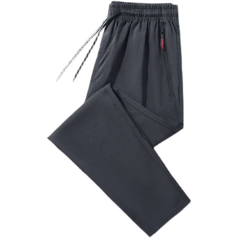 Joggers casuales ajustados para hombre en gris oscuro, con cintura elástica y una sutil presilla roja de la cremallera en el bolsillo lateral.