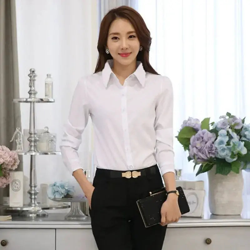 Blouse boutonnée à manches longues blanche avec un col classique et une coupe ajustée, idéale pour les chemises d’automne et d’hiver.