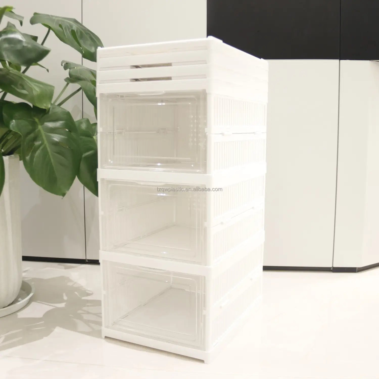 Stackable white plastic storage boxes with clear front panels designed as a shoe organizer for efficient working time and space management.