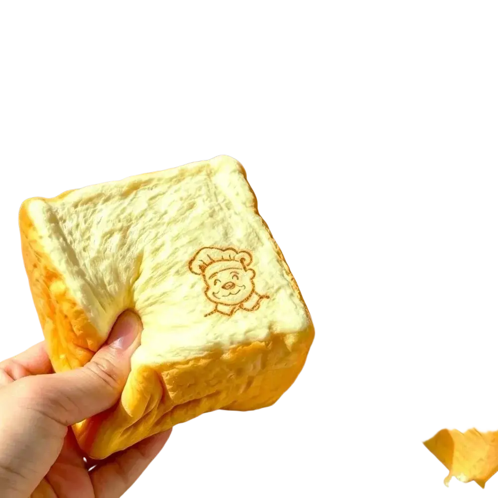 Moist thick simulated bread toast squishy toy with golden-brown fluffy texture and cartoon chef design for universal age range fidget toy