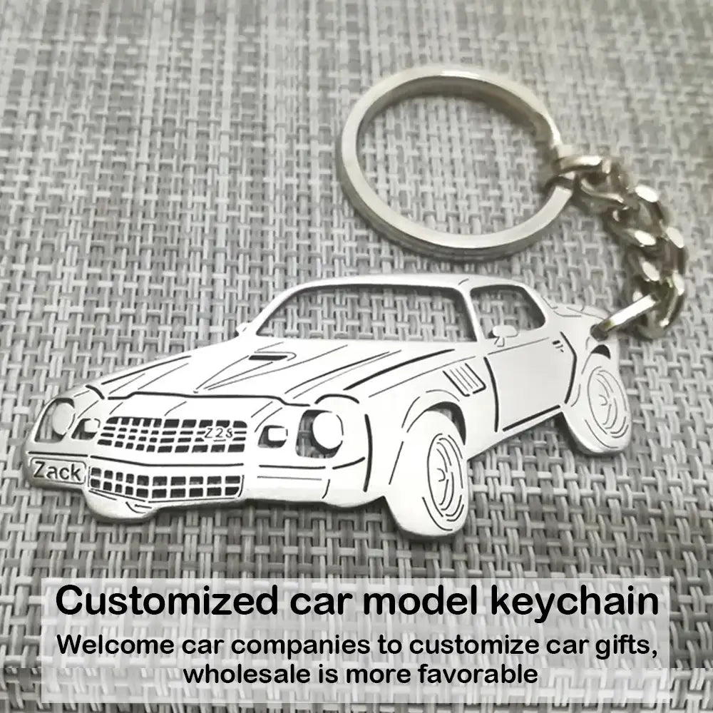Silver metal customized car model keychain with zack and zzs engravings on the front.