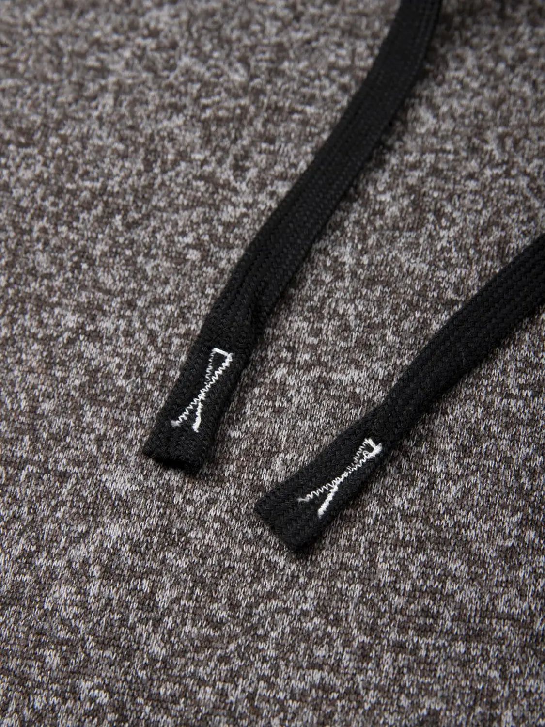 black drawstring with white embroidered logo at each end on a men’s fleece lined knit hooded jacket
