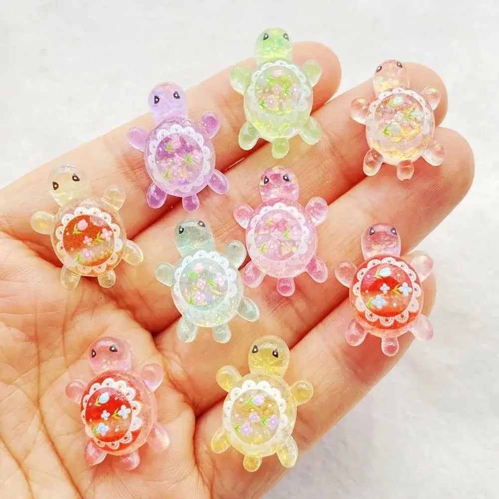 a collection of colorful translucent resin turtle flatback charms with embedded floral and glitter details 10 pack