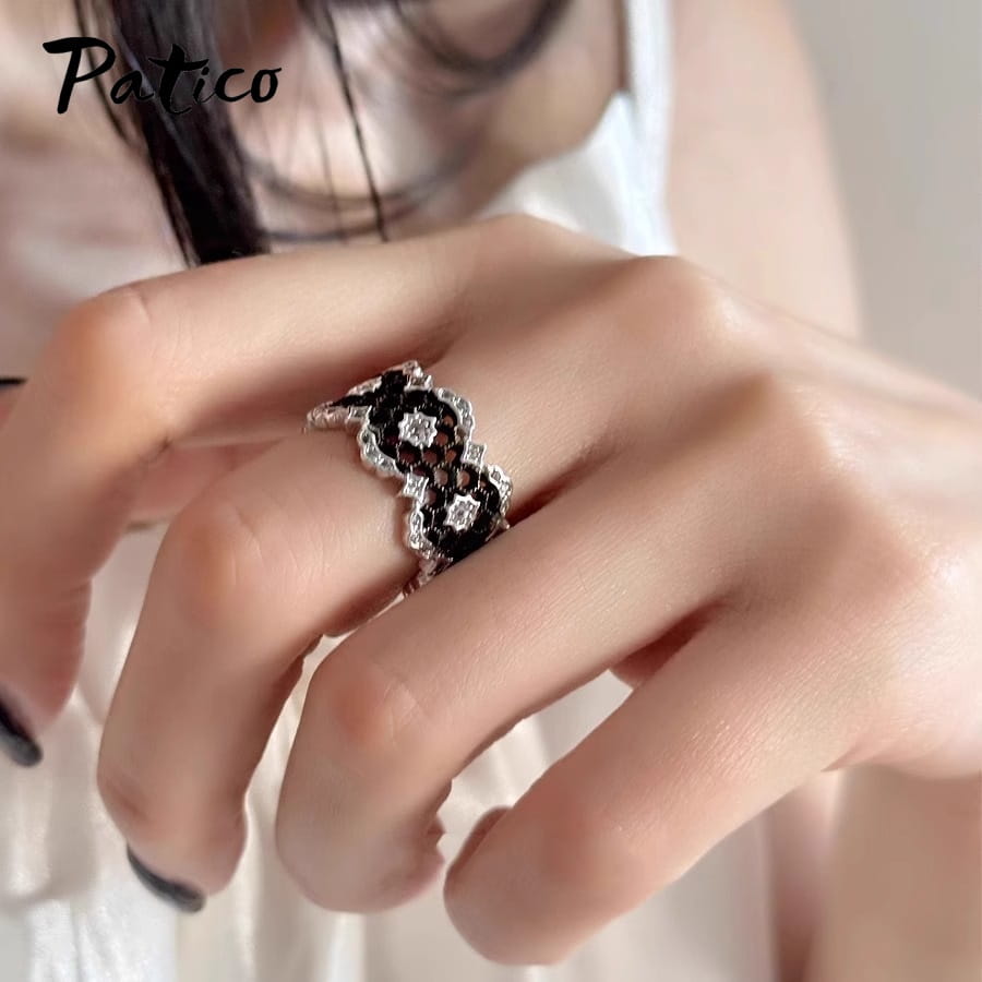 A sterling silver black geometric ring for women featuring a delicate intricate lace-like design accented with sparkling clear stones from patico.
