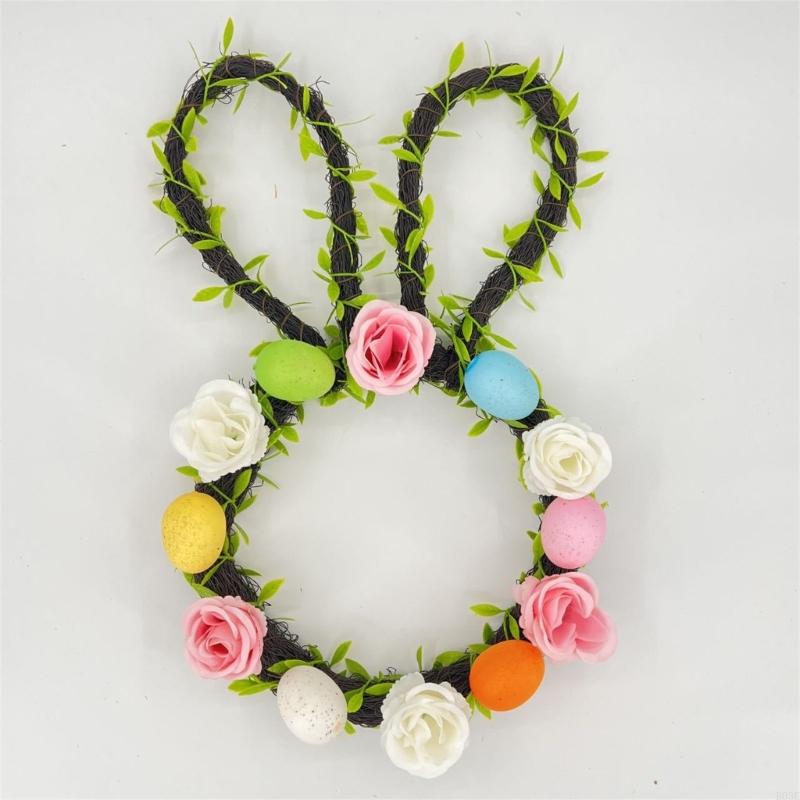 easter bunny floral wreath for front door made of dark green vine with artificial pink white and yellow roses and colorful pastel eggs.