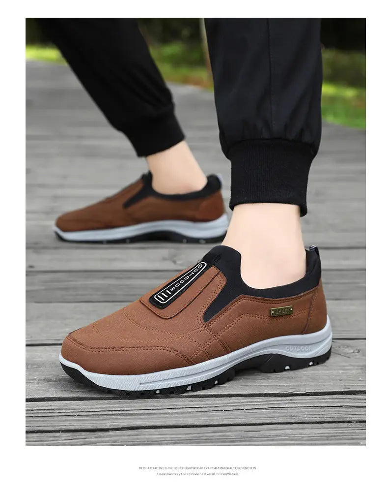 Men orthopedic slip-on walking shoes featuring brown leather with black accents and a white midsole.
