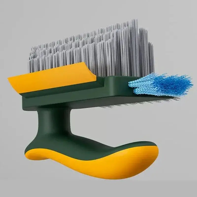 Brosse de nettoyage en forme de V pour carrelage et rainures avec un manche vert et jaune, des poils gris denses et une extrémité éponge bleue contrastante.