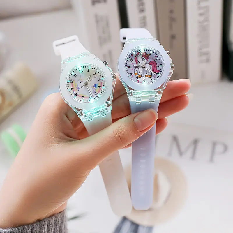 two translucent glowing kids unicorn led light up silicone digital watches with unicorn designs on the dials and soft silicone straps