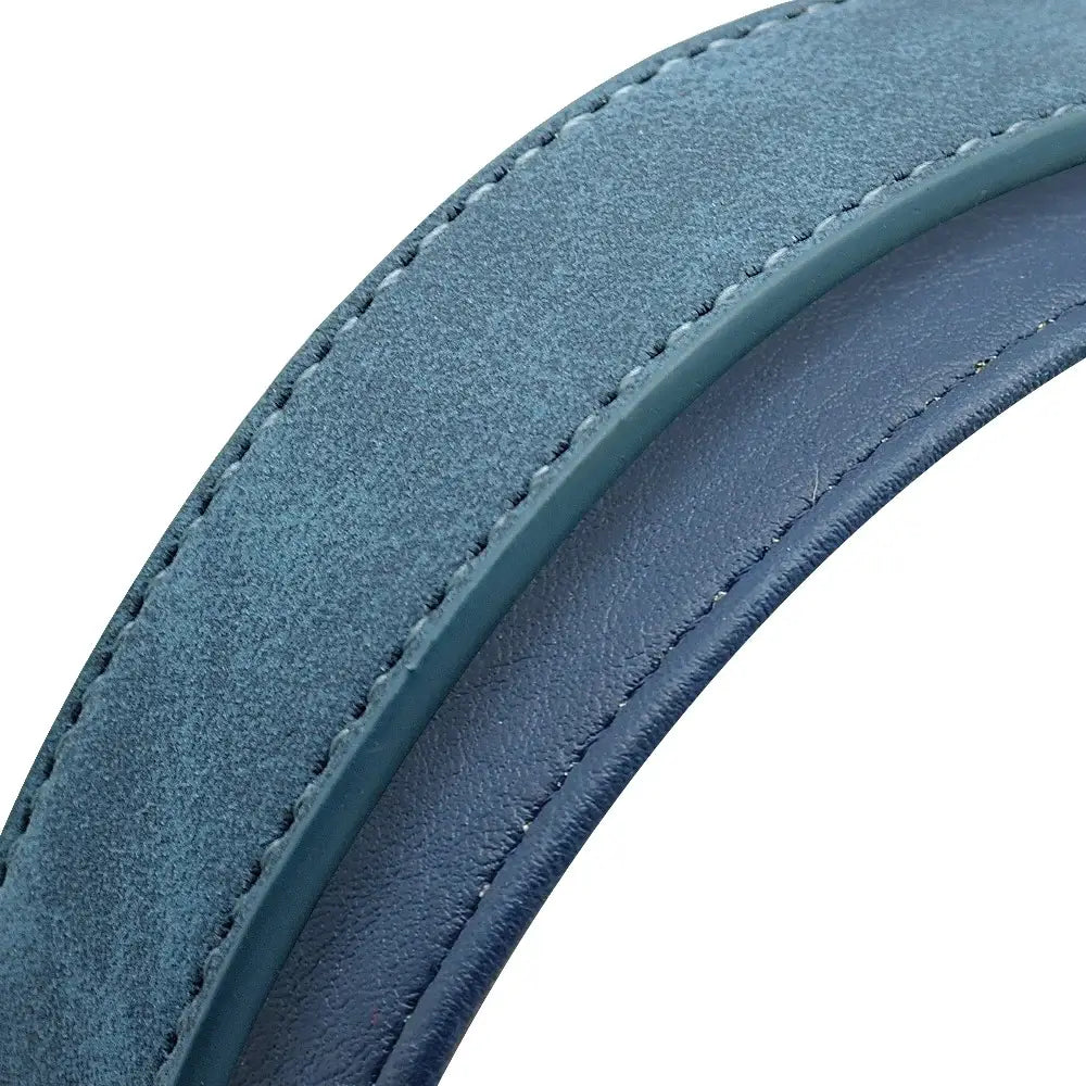 A curved two-toned blue leather dog collar strap with a textured suede outer surface and smoother inner lining for customization information and personalized use.
