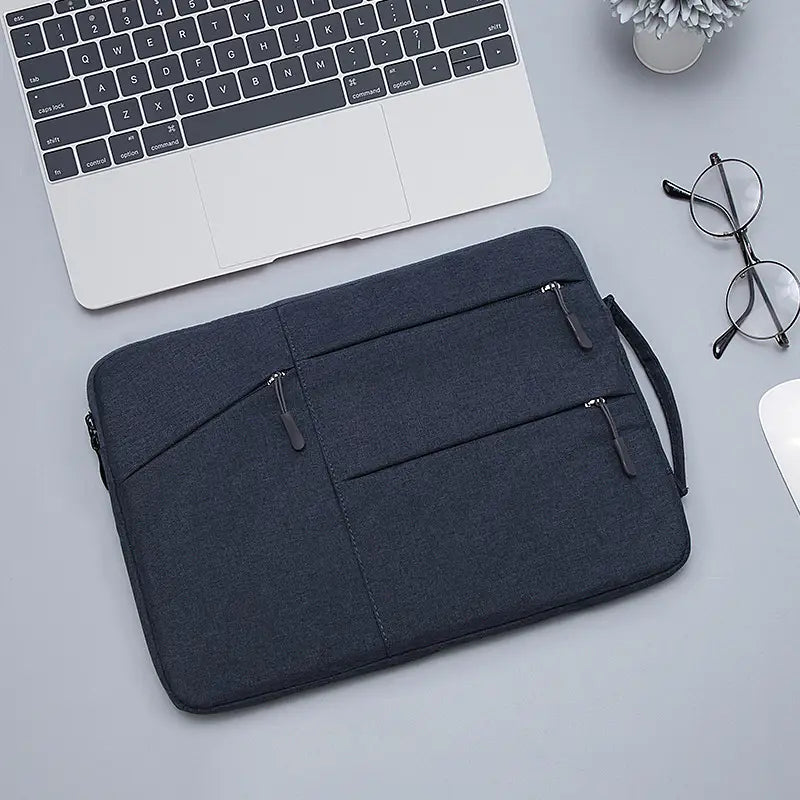 dark gray laptop sleeve bag for MacBook Air and Pro with multiple zippered compartments and a carrying handle designed for secure and organized laptop storage