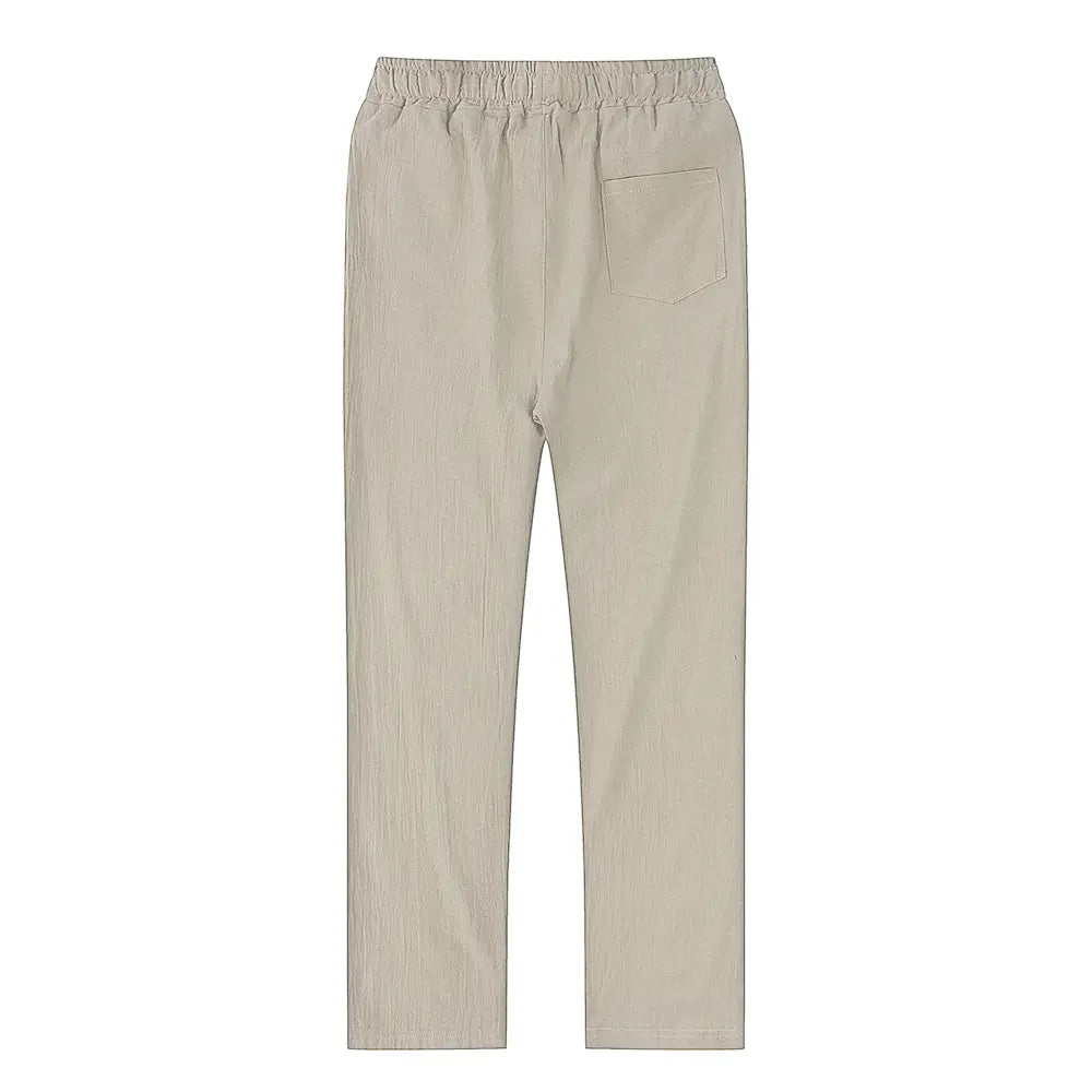 Beige cotton linen trousers with an elastic waistband and a single back pocket shown from the back for breathable casual wear.