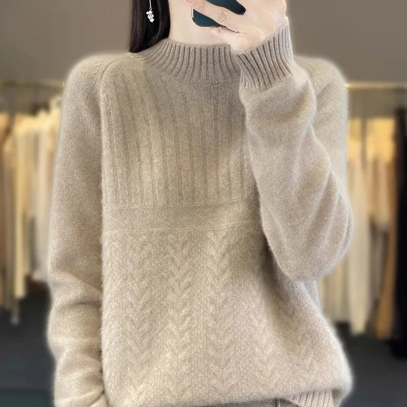 A soft light beige cashmere women’s wool knit pullover sweater with a ribbed crew neckline and long sleeves featuring a subtle herringbone knit pattern.
