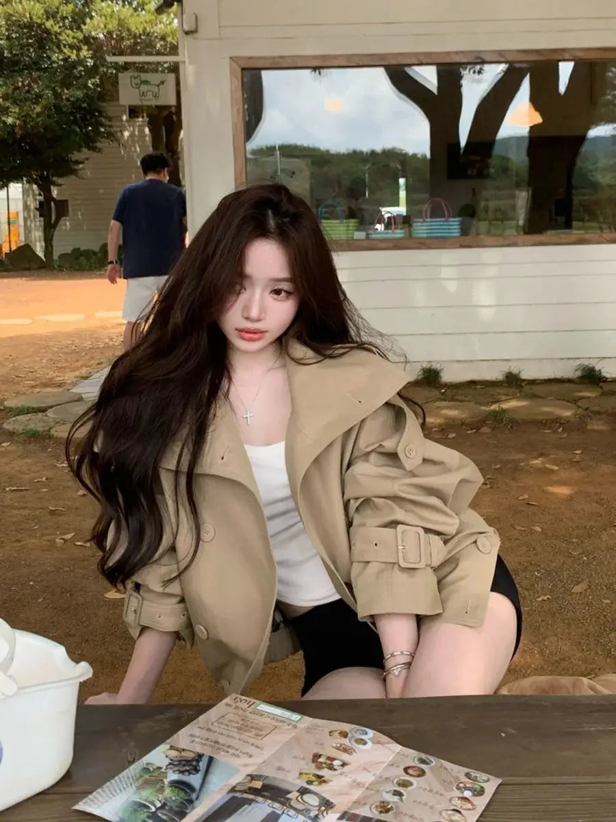 Women korean trench coat beige utility jacket featuring a belted waist and buttoned front made from lightweight fabric.