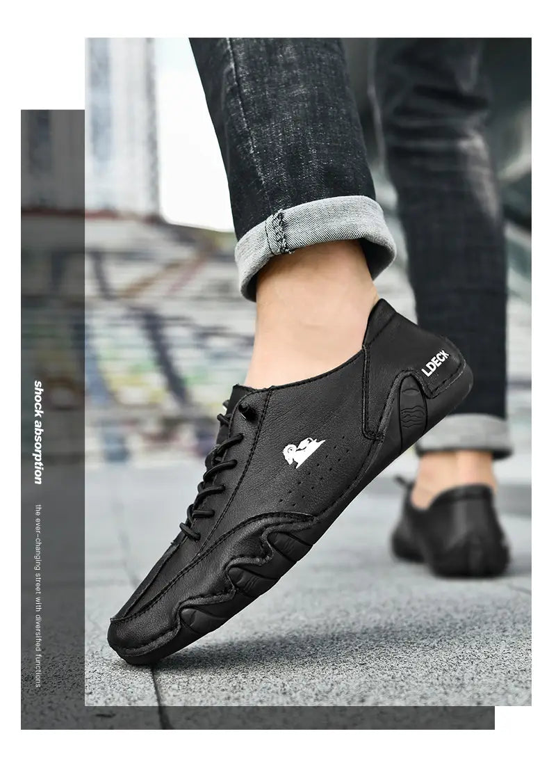 Black leather lace-up men high top casual sneaker with a white heart logo on the side and ldeck branding near the heel.