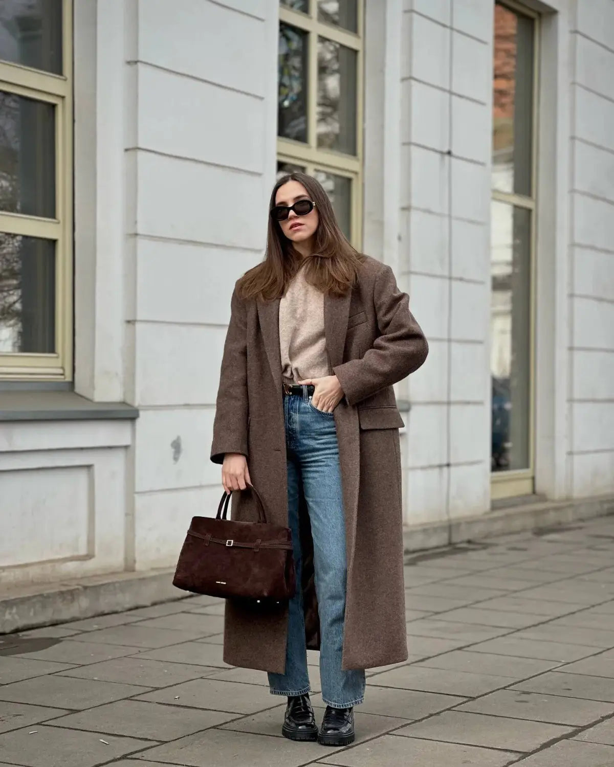 brown suede handbag with a structured rectangular shape and top handle complementing a brown wool blend overcoat for women winter commuter jacket.