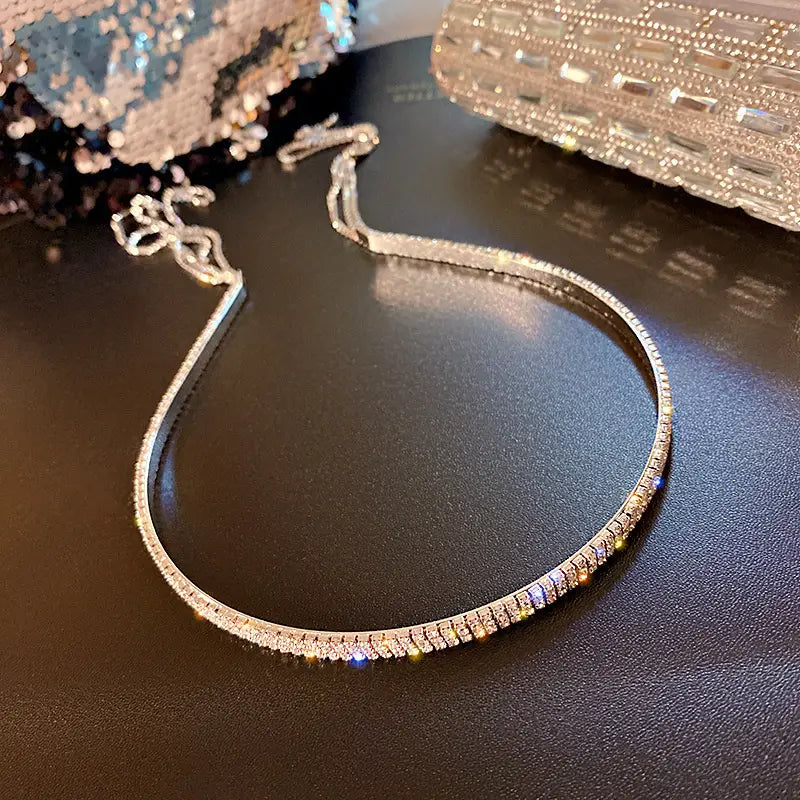 A sleek silver-toned choker necklace with a continuous row of sparkling rectangular-cut crystals designed as a crystal rhinestone tassel headband for women.