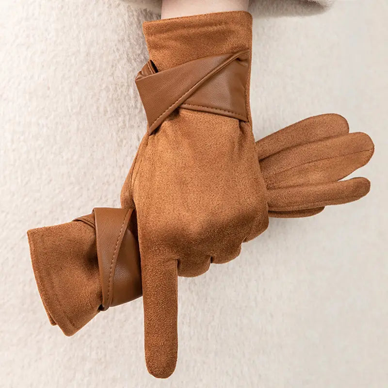 Guantes de invierno para mujer con pantalla táctil de ante color canela, con lazo de terciopelo y una correa de cuero lisa sobre la muñeca, mostrados desde el lado posterior