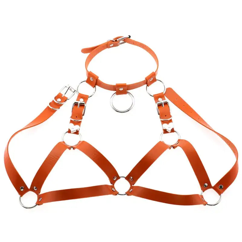 Orange faux leather goth body harness featuring silver metal rings and buckles as body jewelry for black goth body styles.