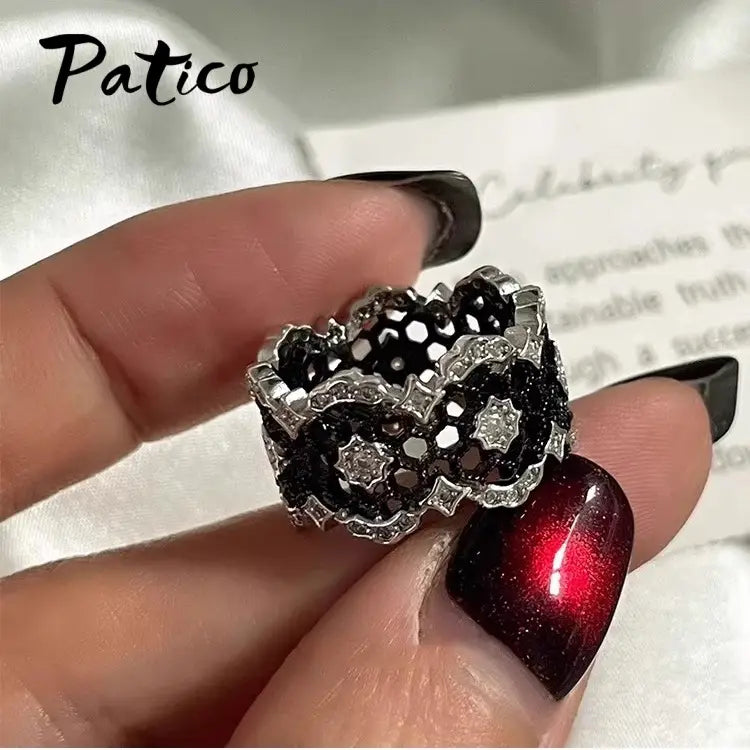 Sterling silver black geometric ring for women featuring a black and silver lace pattern with embedded clear crystals by Patico.