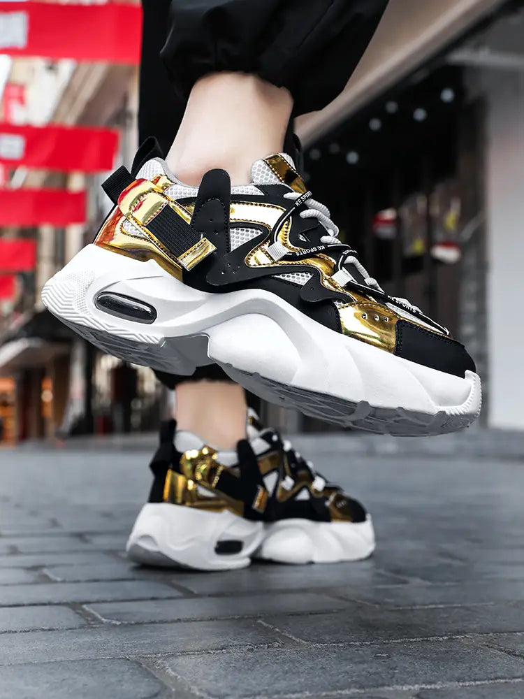 Men chunky air cushion casual sneaker in black and gold with mesh upper and white rubber sole.
