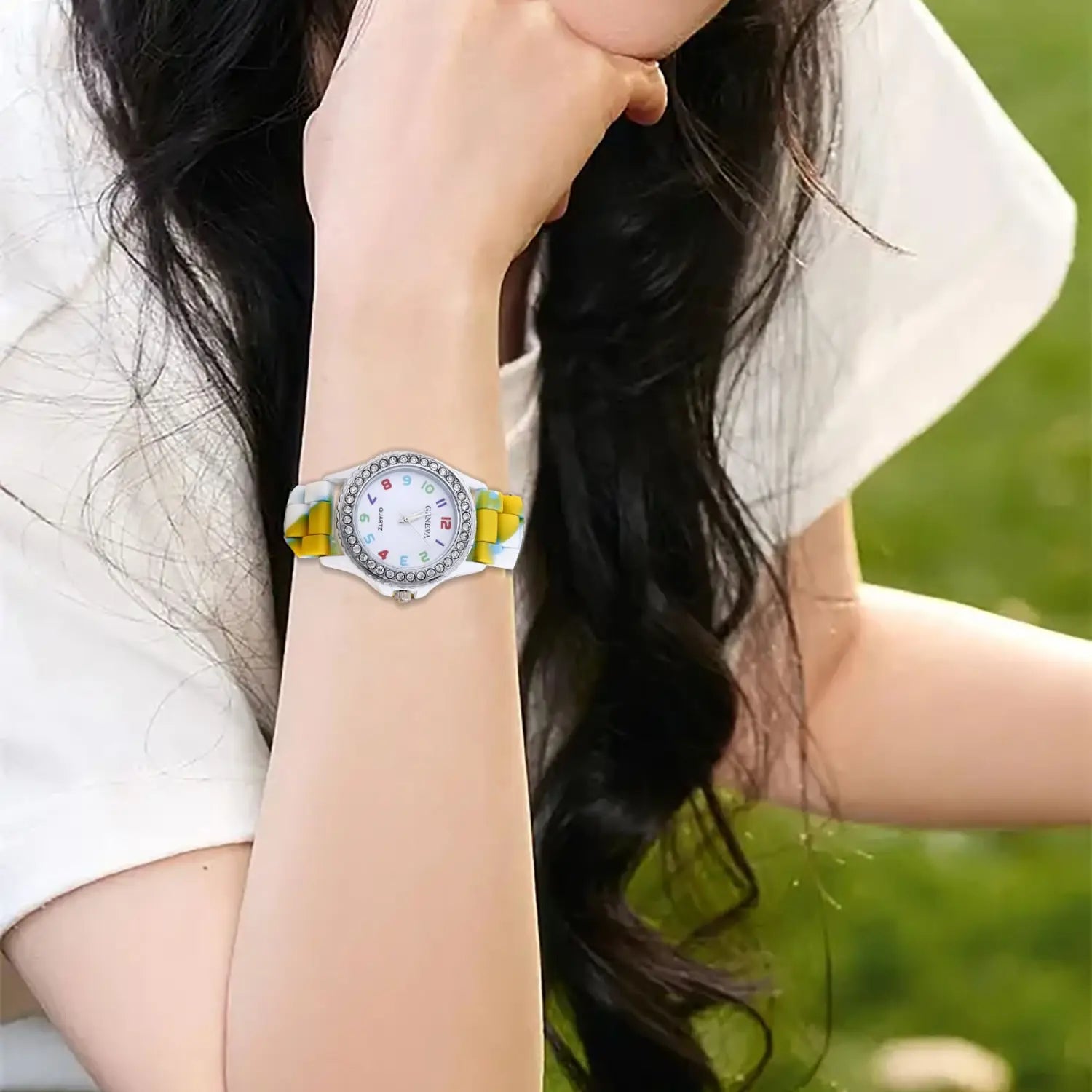 A girls crystal bling rainbow silicone watch featuring a stylish yellow and white silicone strap with a silver-toned case adorned with sparkling rhinestones around the bezel.