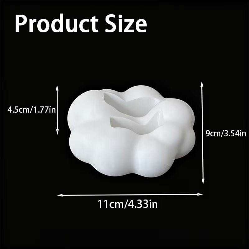 White cloud-shaped silicone remote control holder with a central cavity for organizing desktop remote controls.