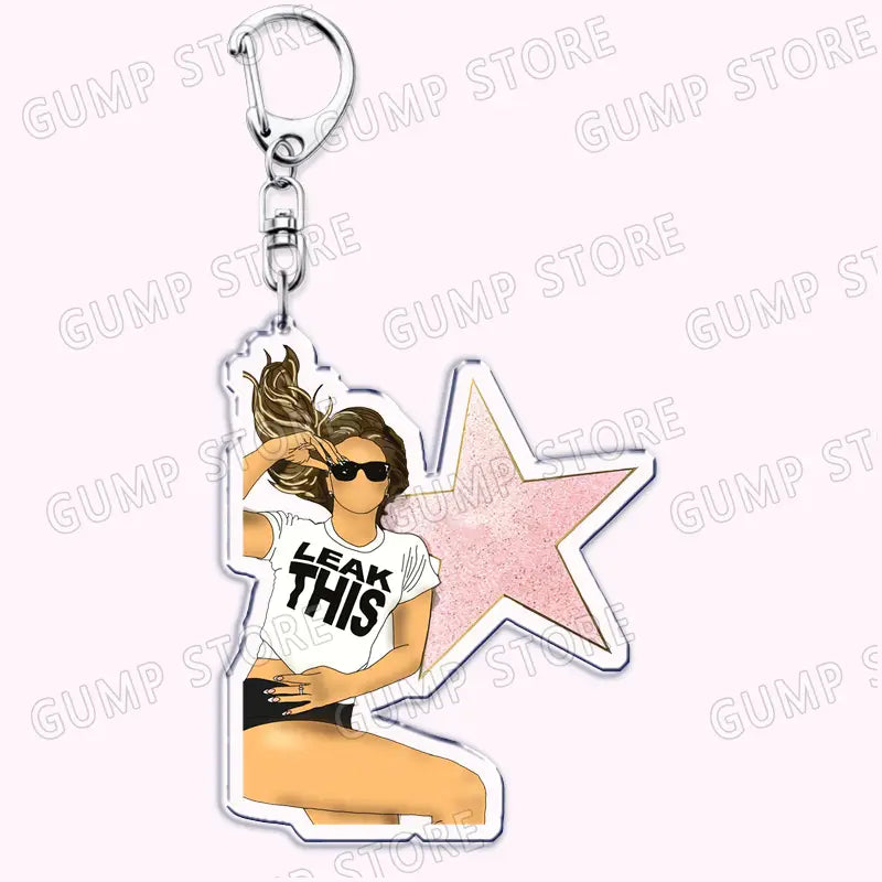 Clear acrylic Tate Mcrae keychain featuring a cartoon woman in sunglasses and a white t-shirt with leak this text against a pink star background.