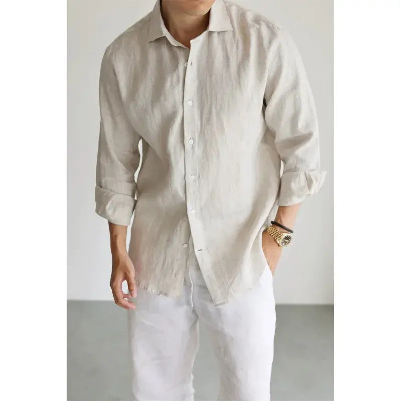 men cotton linen casual button down shirt in light beige featuring long sleeves, rolled cuffs, and a slightly frayed hem made of breathable linen material.