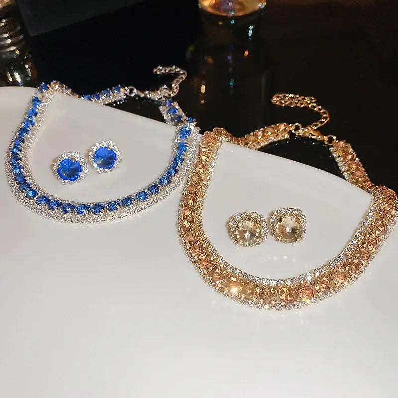 Blue and gold crystal necklace and earring set with sparkling rhinestones set in silver-toned metal frames for wedding jewelry.