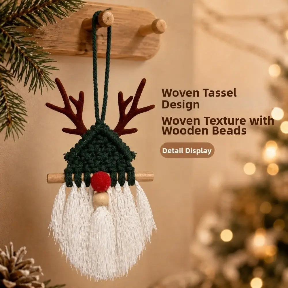 A festive green and white macrame christmas wall hanging tapestry featuring a reindeer ornament with wooden antlers, a red nose, and decorative tassels.