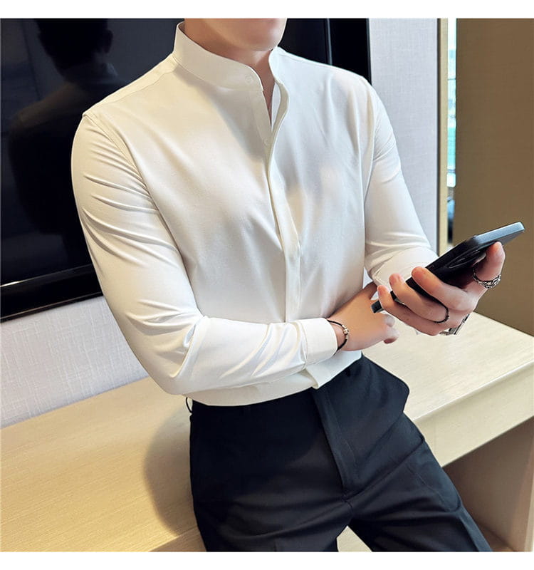A sleek white long-sleeved men dress shirt with a slim fit stand collar and subtle sheen designed for formal occasions and correct size fit.
