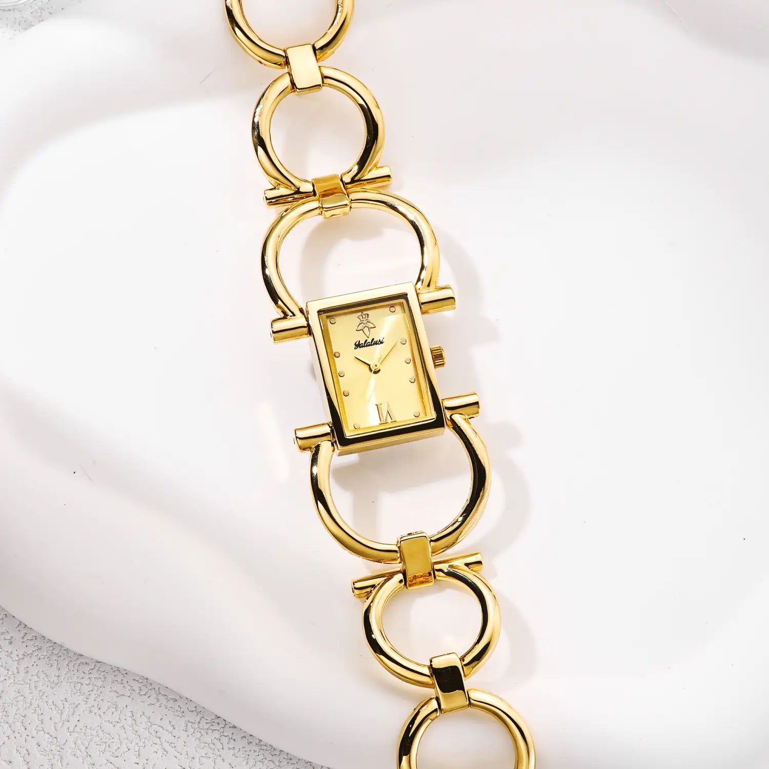 Gold luxury quartz women watch bracelet with a gold-toned rectangular case, cream-colored dial featuring roman numerals, and a distinctive horsebit-style link bracelet.