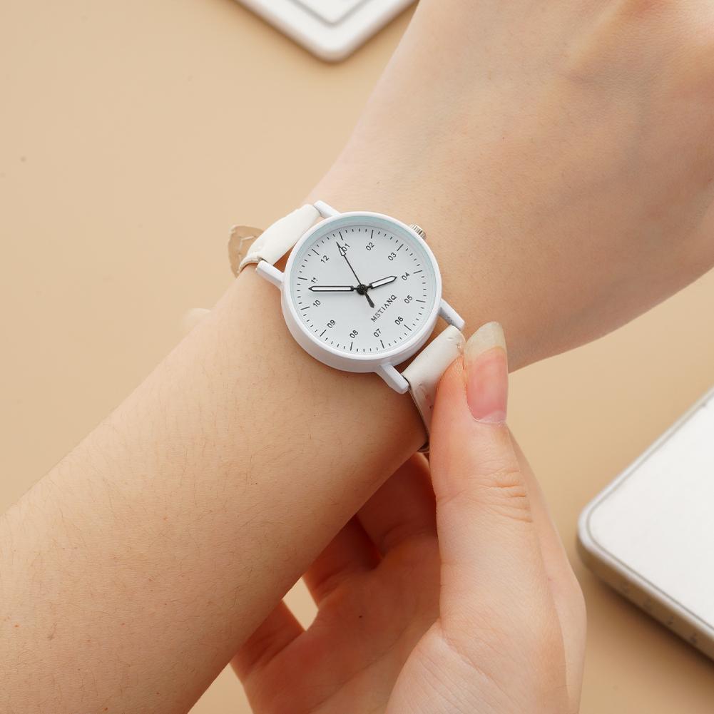 White minimalist women quartz watch with a sleek smooth pu leather strap and clean dial markings designed as a waterproof wristwatch.