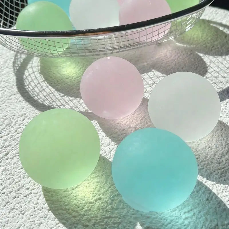 pastel-colored translucent stress balls in soft pink mint green and light blue hues designed as blue mochi squeeze sensory fidget toys for stress relief and sensory play.