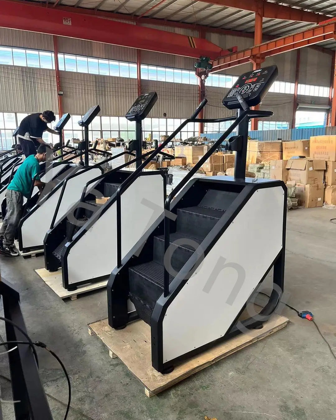 Black and white commercial stair climber machine cardio stepmill with digital display panel for cardiovascular exercise.